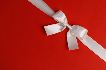 White gift bow on red