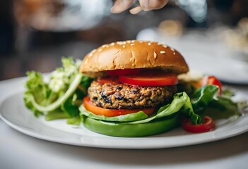 a plate with a burger and lettuce on it