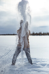Cheerful man having fun in snowy tundra during holidays.