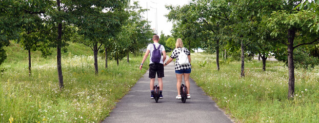Man and woman riding electric unicycles
