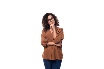 young european curly woman with black hair dressed in a blouse freestanding on a white background with copy space