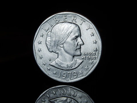 Susan B Anthony portrait on dollar coin, on a black background