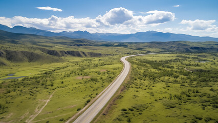An empty road in an endless grassland seen from a drone