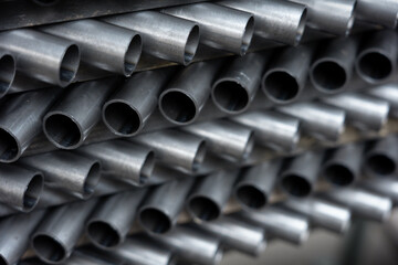 Stack of steel pipes. Close - up of stack of metal pipes. Industrial elements closeup. Parts...