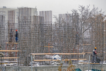 Builders erect the foundation on an autumn day