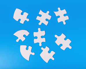 Scattered puzzle pieces in chaos. Jigsaw challenge