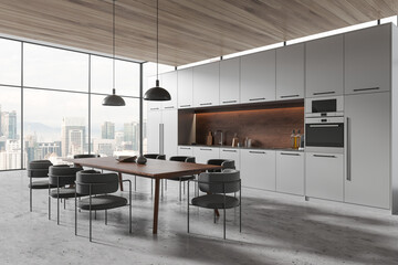 Panoramic gray kitchen corner with dining table
