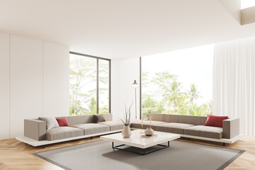 White living room corner with sofas and table