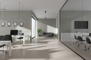 Light gray open space office interior with clocks