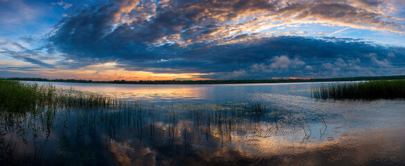 The nature of Belarus, a serene summer morning, a bright dawn on Lake Selyava