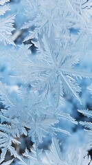 Micro snowflakes on blurred blue background. New Year and Christmas background snowflake.