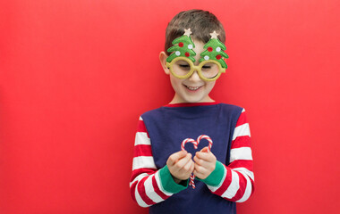 Caucasian boy on red Christmas background
