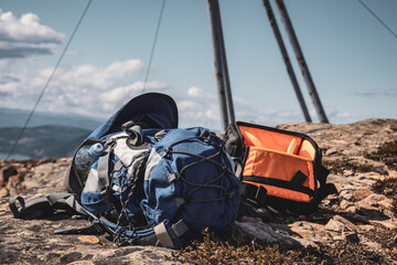 A backpack lying on a rock above.