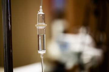 Saline solution IV (intravenous) drip for a hospital patient. Closeup photo.