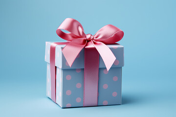 Obraz premium An image of a gift box with a pink ribbon on a pink and blue background