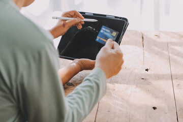 Close up mature man holding plastic credit card, senior couple family paying online, using laptop, satisfied older customers making secure internet payment, shopping, browsing banking service