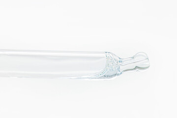 Cosmetic pipette with blue and blue gel, serum, serum on a light background.