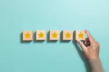 Customer holding wooden cube with star icon give five star rating. Concept for Service rating,...