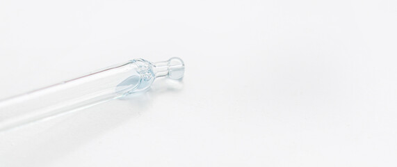 Cosmetic pipette with blue and blue gel, serum, serum on a light background.