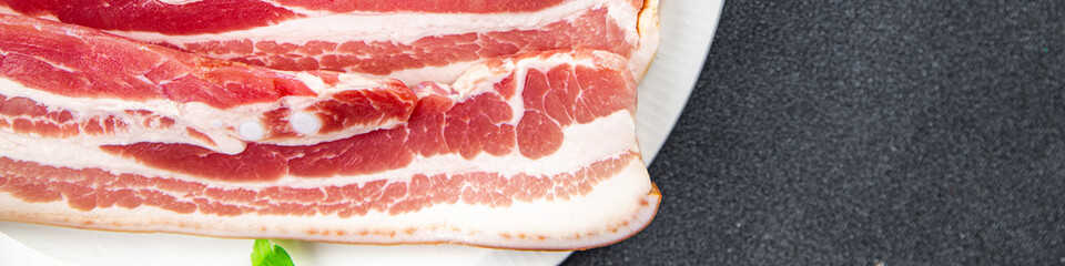 Obraz premium fresh bacon slice meat pork eating cooking appetizer meal food snack on the table copy space food background rustic top view