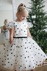 Little girl of model appearance in a beautiful dress. Fashion show.