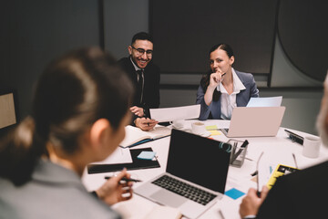 Coworkers discussing project presentation in office
