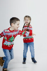 Preschool boy, girl in Christmas sweaters