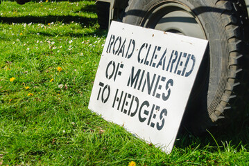 Sign advising that the road has been cleared of mines to the hedges at a World War 2 reenactment
