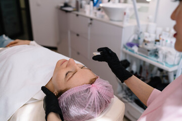 Female client getting treatment in beauty clinic