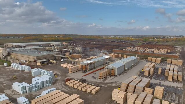 Aerial video of lumber yard and sawmill in Alberta, Canada on an autumn day