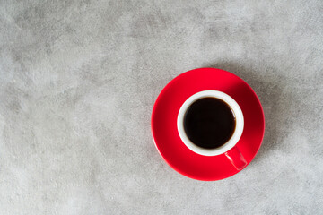 Top view red doppio normale ceramic 80ml or 2oz espresso cup with saucer placed on loft industrial...