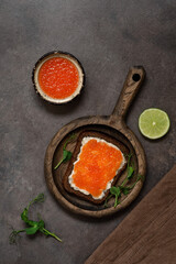 Sandwich with red salmon caviar. Top view, flat lay. Vertical