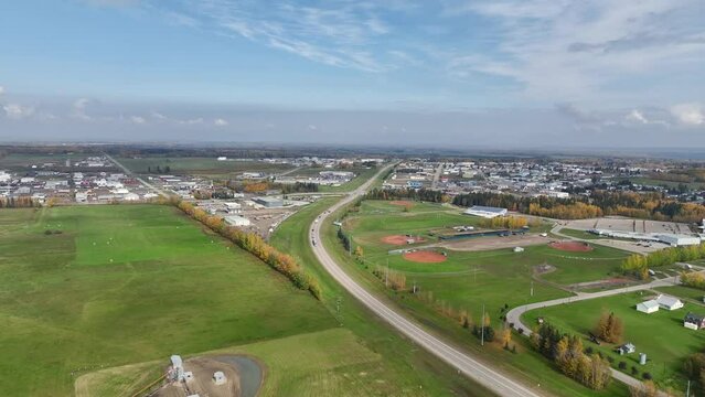 Drayton Valley, Canada - Aerial 4K drone video of small town sprawled across flat landscape in northern Alberta 