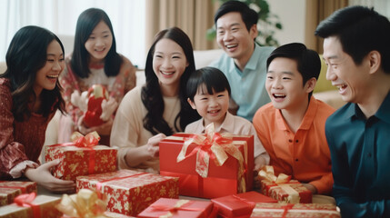 Chinese families wear red traditional clothing with gift boxes in Chinese lunar New Year