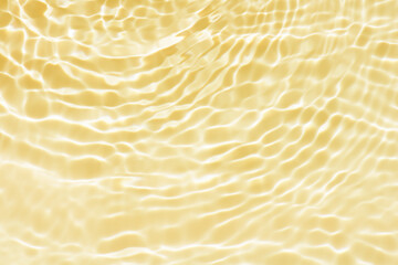 Defocus blurred transparent gold colored clear calm water surface texture with splashes reflection....
