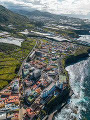 ocean shore with blue water, cozy town with hotels and villas, Tenerife, Canary