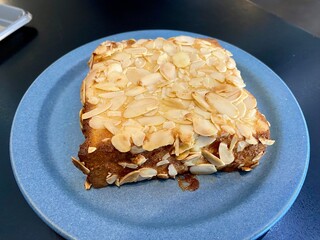 Toast shokupan bake with almond sliced and sweet sauce for dessert bread breakfast brunch concept 