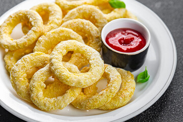 onion rings  fast food deep fryer batter tomato sauceeating cooking appetizer meal food snack on...