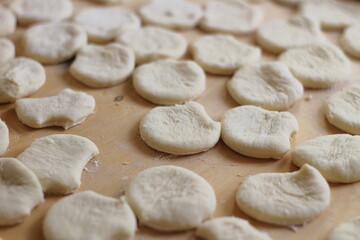 Fototapeta na wymiar Preparing the dough for creating dumplings