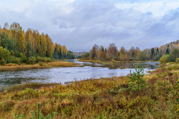 Fototapeta na wymiar Forest landscape and a small river in the northern regions of Russia in late autumn.