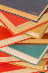 abstract books background - old red and muted green ones in a vertical stack.