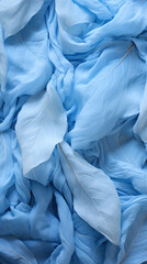 Blue crumpled fabric as background, top view. Close up abstract gentle transparent leaves, cyber silverpoint impressionism