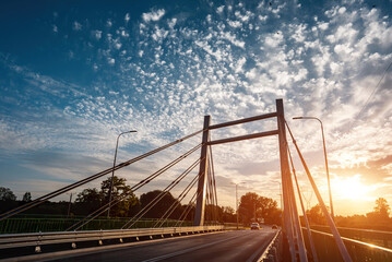 modern metal cable bridge over Bystrzyca river, sunset, Zeglarska street, Lublin - obrazy, fototapety, plakaty