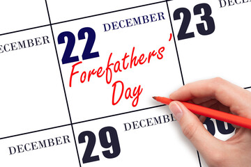 December 22. Hand writing text Forefathers' Day on calendar date. Save the date.