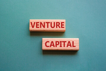 Venture capital symbol. Wooden blocks with words Venture capital. Beautiful grey green background....