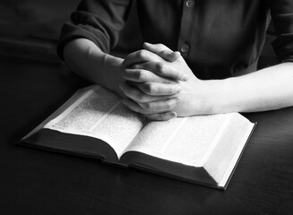 Woman's hands holding a bible