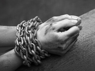 Women's hands in iron chains