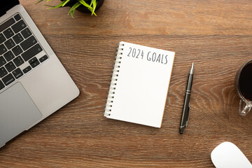 Notebook with 2024 goals text on it to apply new year resolutions and plan.