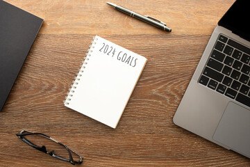 Notebook with 2024 goals text on it to apply new year resolutions and plan.