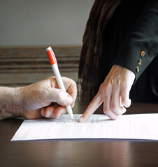 An old woman is forced to write a will for an apartment